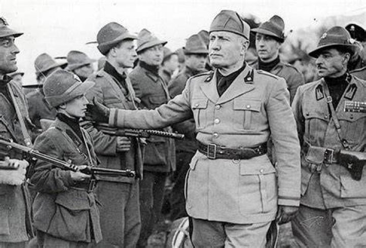 Benito Mussolini taps the cheek boy