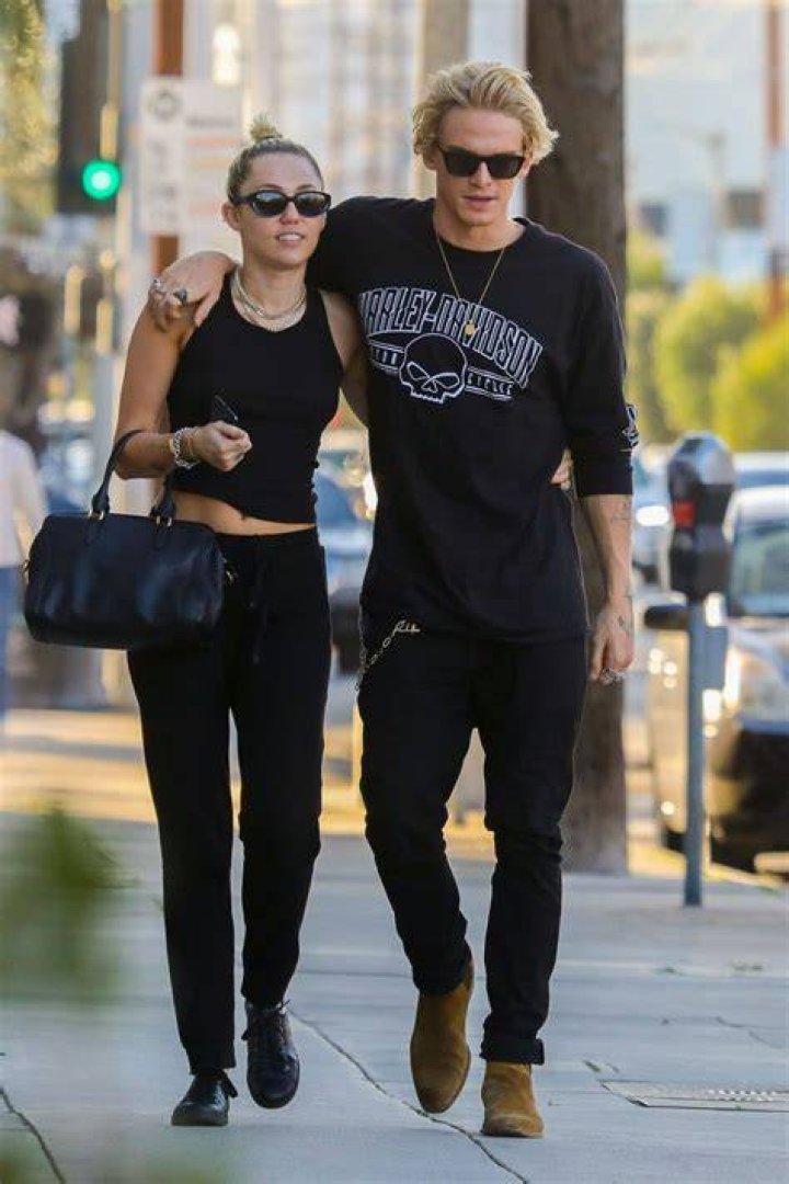 Miley Cyrus and Cody Simpson Snuggling With a Dog